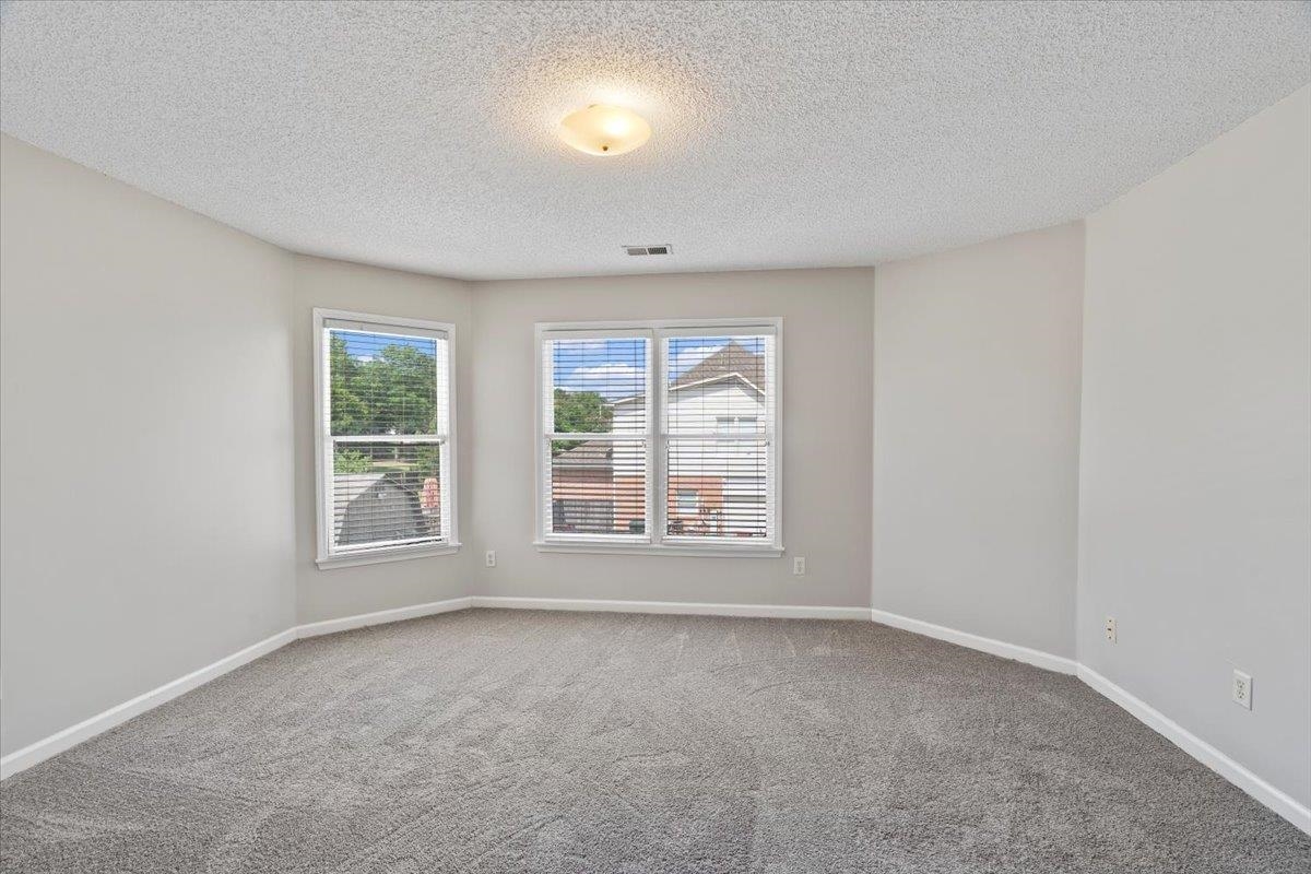 1675 John Ridge Drive Collierville, TN 38017 - Photo 28 of 39 Carpeted spare room featuring a textured ceiling and baseboards