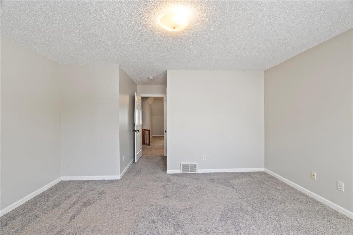 1675 John Ridge Drive Collierville, TN 38017 - Photo 29 of 39 Spare room with a textured ceiling, carpet, and baseboards