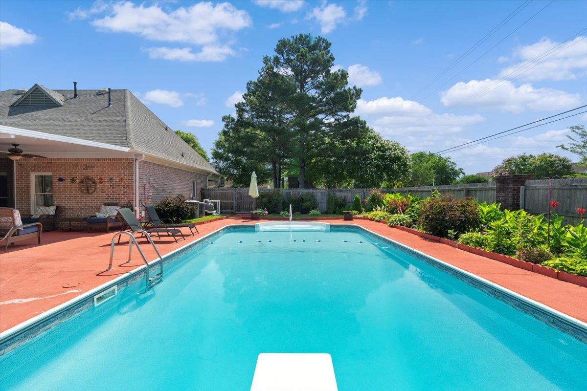 1675 John Ridge Drive Collierville, TN 38017 - Photo 36 of 39 View of swimming pool featuring a fenced backyard, a patio area, ceiling fan, and a diving board