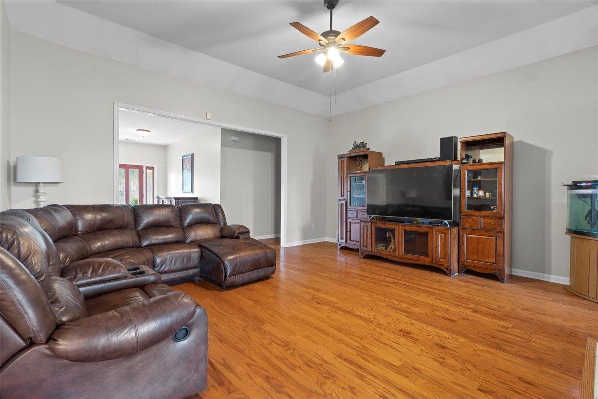 1675 John Ridge Drive Collierville, TN 38017 - Photo 8 of 39 Living room featuring light wood finished floors, a ceiling fan, and baseboards