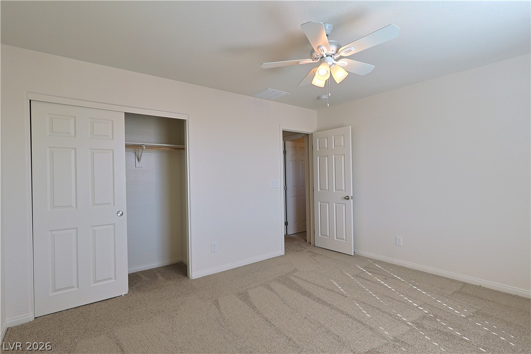 8663 Reynolds Spring Street Las Vegas, NV 89178 - Photo 26 of 32 Soft carpeting pairs with neutral walls to create a serene and inviting atmosphere.