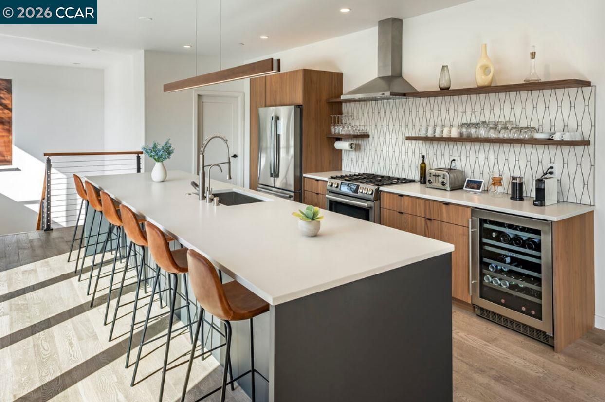 1110 Sterling Avenue Berkeley, CA 94708 - Photo 10 of 25 a kitchen with stainless steel appliances a sink a stove a refrigerator and cabinets