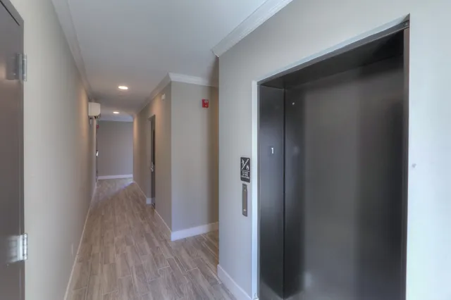 a view of hallway with wooden floor