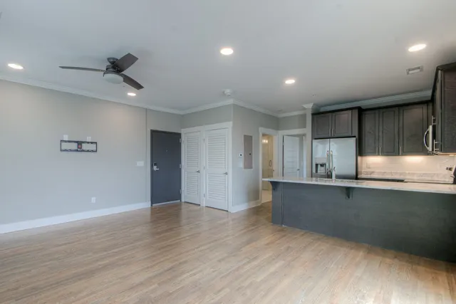a view of a kitchen with a sink and wooden floor