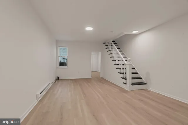 a view of wooden floor and windows in a room