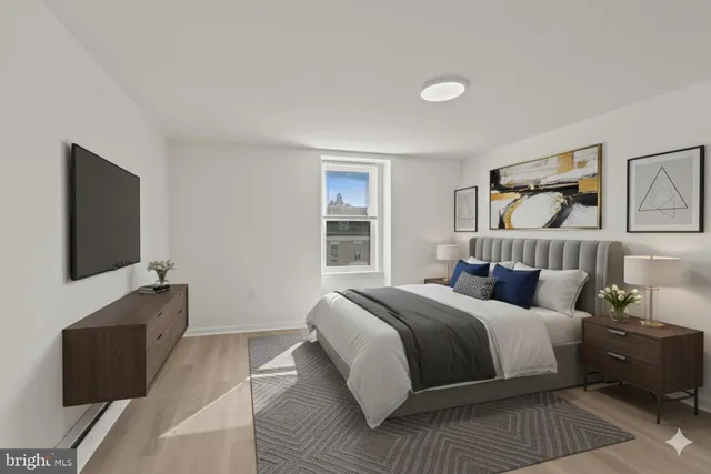 a bedroom with a bed and a flat screen tv