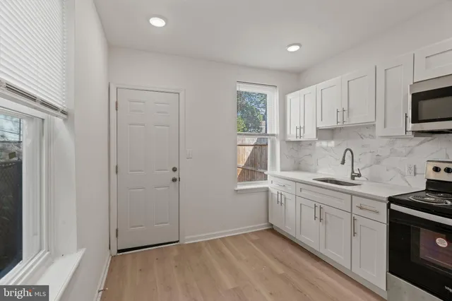a kitchen with a sink cabinets and a window