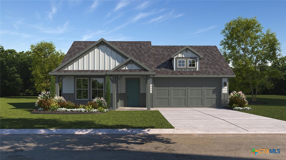 a front view of a house with a garden and plants