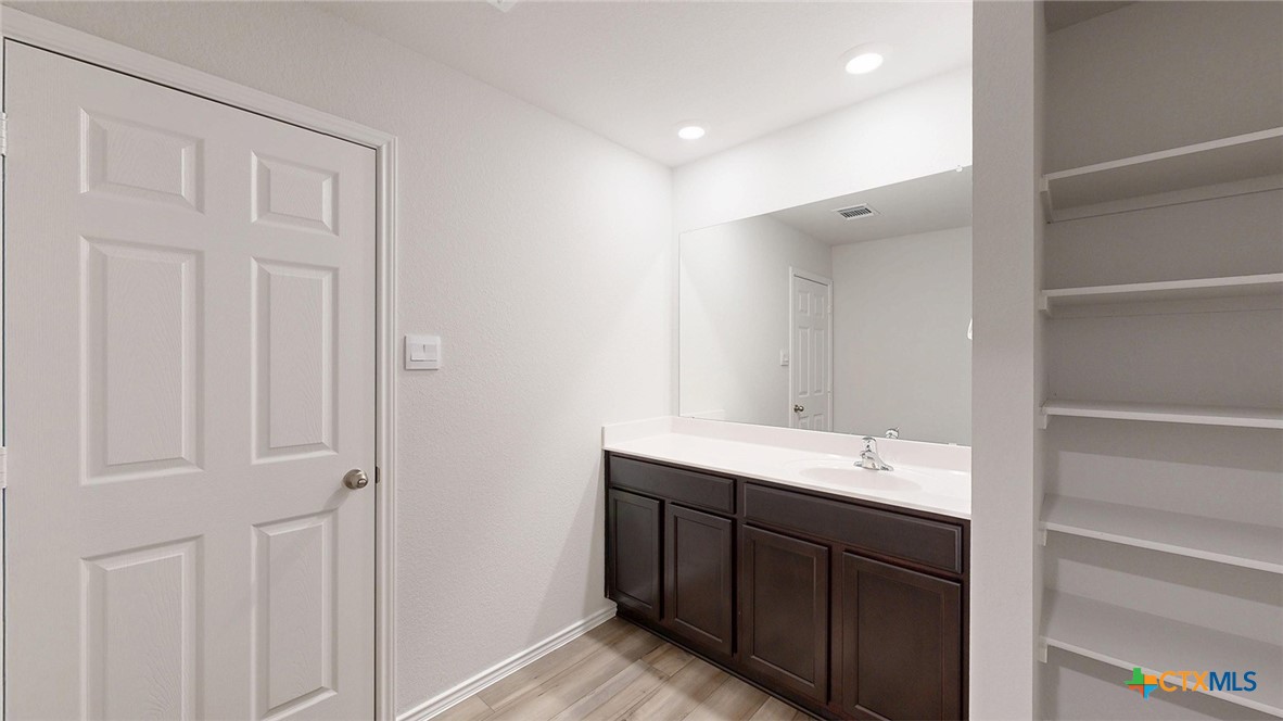 1302 Merritt Road Temple, TX 76504 - Photo 11 of 31 a bathroom with a double vanity sink and a mirror