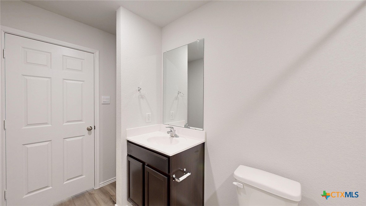 1302 Merritt Road Temple, TX 76504 - Photo 25 of 31 a bathroom with a sink a toilet and a mirror
