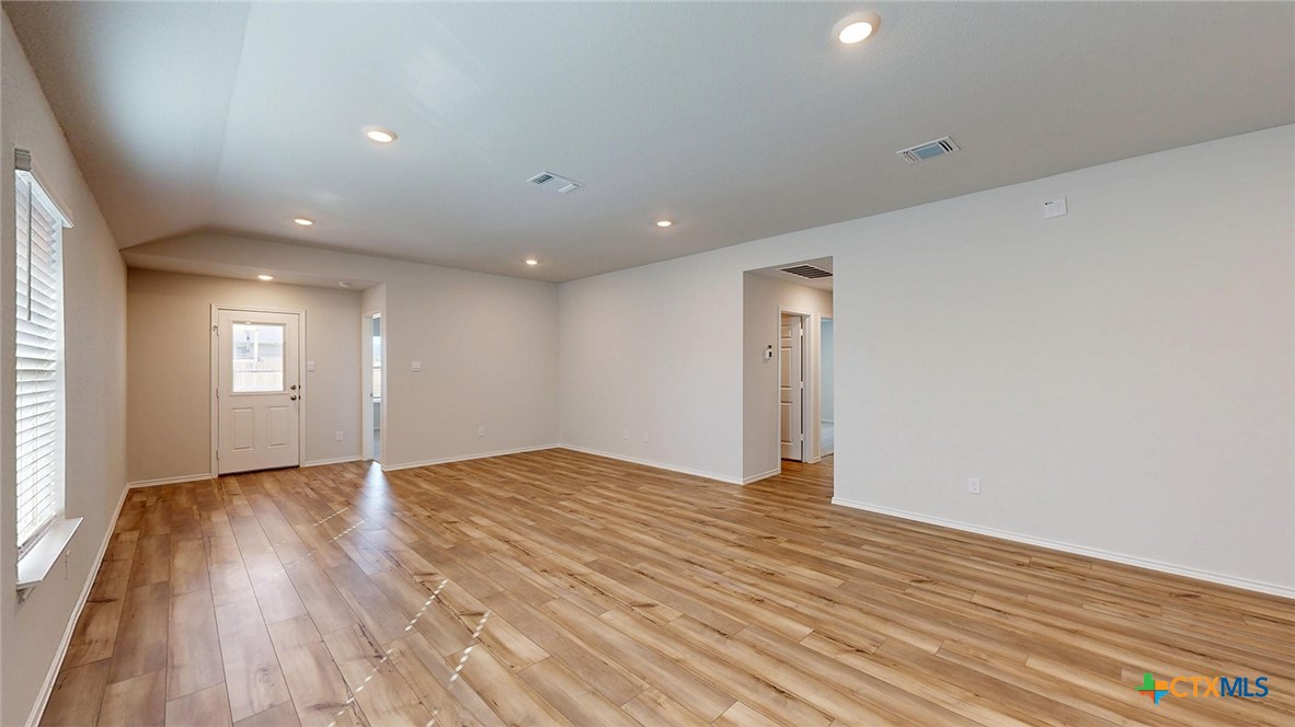 1302 Merritt Road Temple, TX 76504 - Photo 6 of 31 a view of an empty room with wooden floor and a window