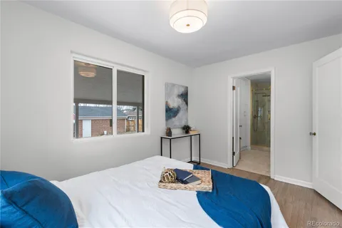 a bedroom with a bed and wooden floor
