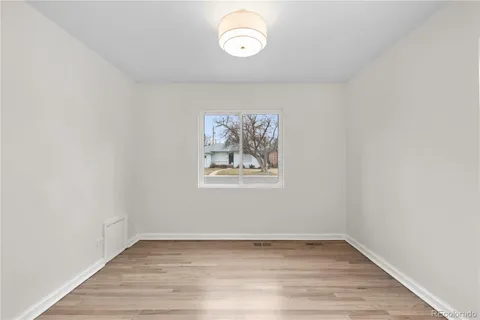 a view of a room with wooden floor and window