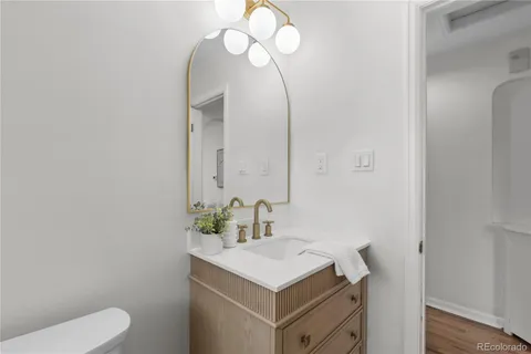 a bathroom with a sink vanity and a toilet