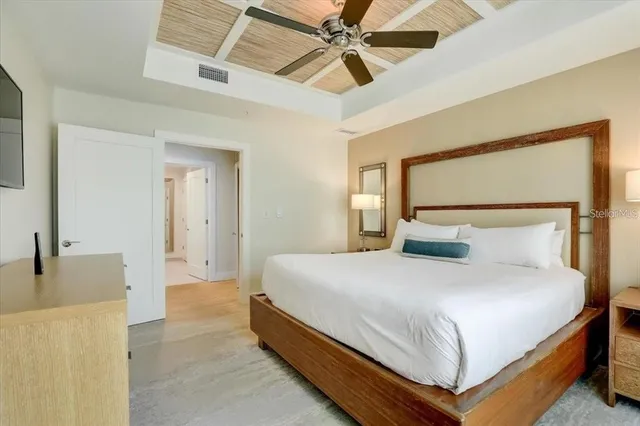 a bedroom with a bed and a chandelier