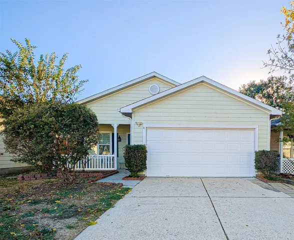a front view of house with yard and trees
