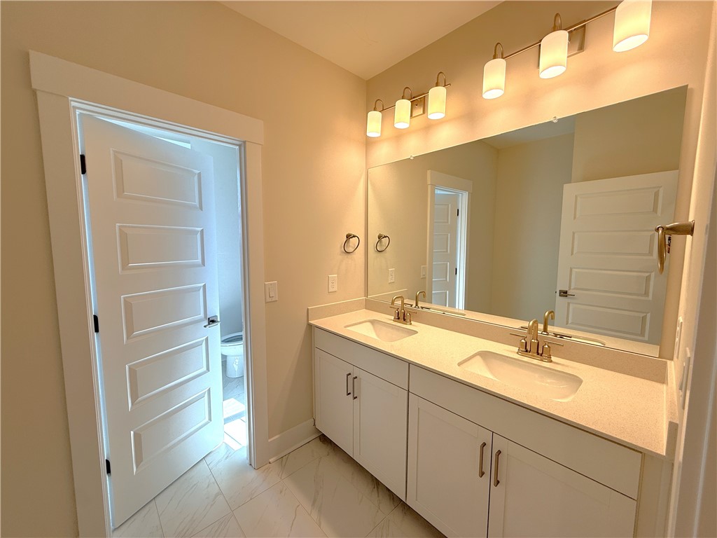 504 Tilman Court Anderson, SC 29621 - Photo 23 of 28 This bathroom features a double vanity and sleek modern finishes, offering both style and functionality.