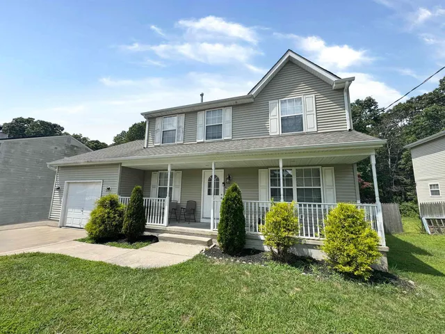 a view of a house with a yard and plants with a garden