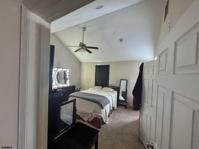 a bedroom with a bed and a mirror