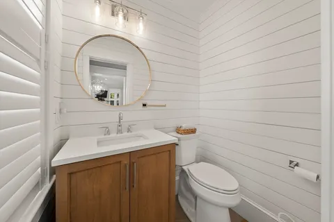 a bathroom with a sink a toilet and mirror