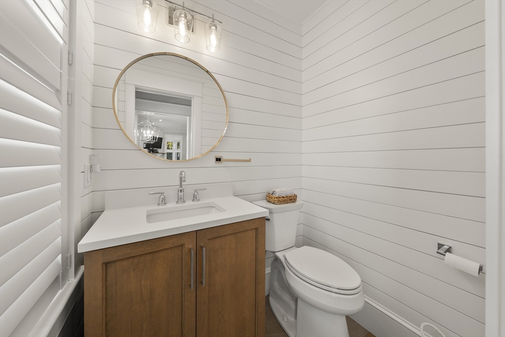 74-76 Butler Road Quincy, MA 02169 - Photo 14 of 41 a bathroom with a sink a toilet and mirror