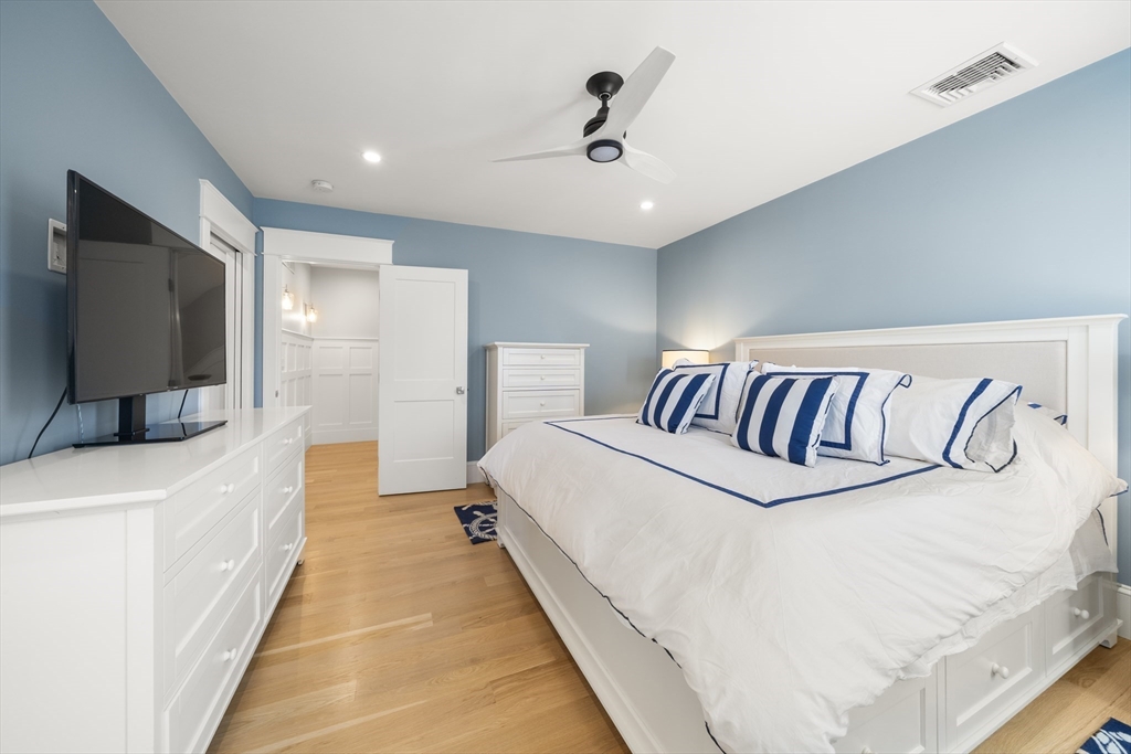 74-76 Butler Road Quincy, MA 02169 - Photo 17 of 41 a spacious bedroom with a bed and a flat screen tv