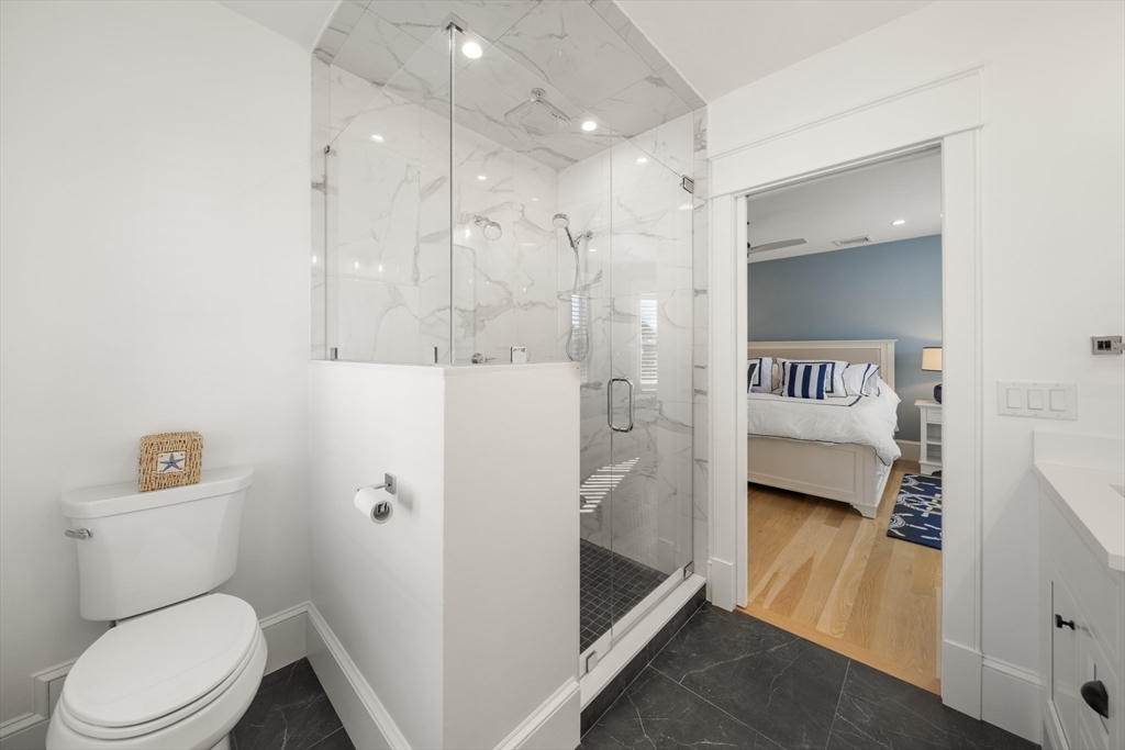 74-76 Butler Road Quincy, MA 02169 - Photo 18 of 41 a en suite bathroom with a toilet sink and shower