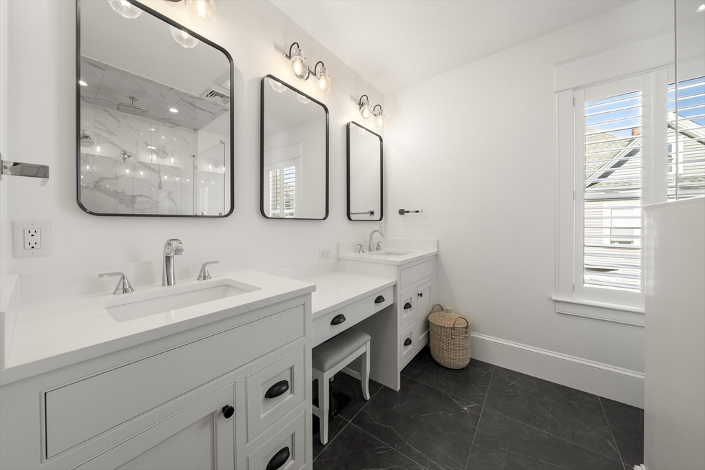 74-76 Butler Road Quincy, MA 02169 - Photo 19 of 41 a spacious bathroom with a double vanity sink mirror and window