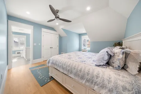 a bedroom with a large bed and a chandelier
