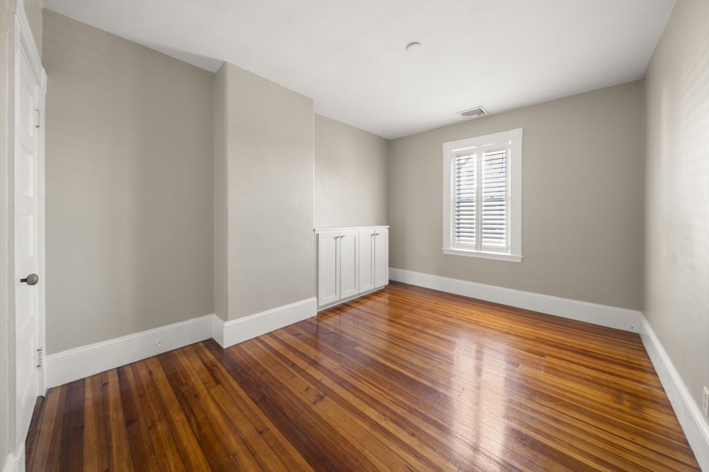 74-76 Butler Road Quincy, MA 02169 - Photo 25 of 41 a view of an empty room with wooden floor and a window