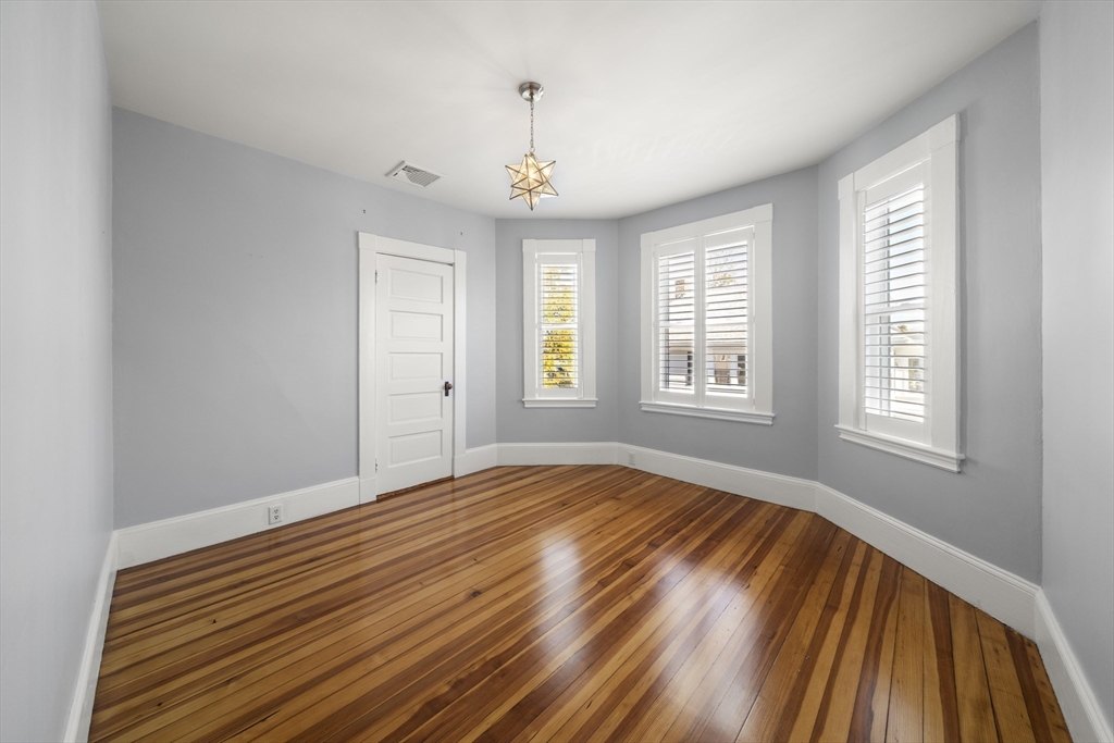 74-76 Butler Road Quincy, MA 02169 - Photo 26 of 41 a view of an empty room with wooden floor and a window