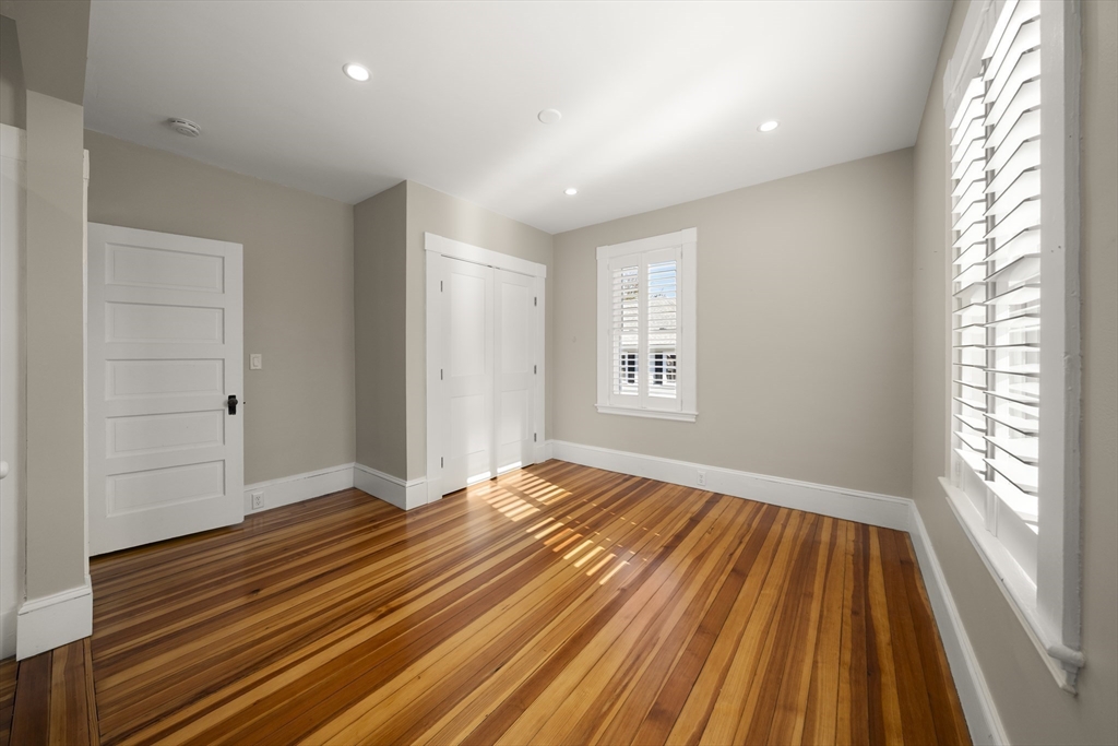 74-76 Butler Road Quincy, MA 02169 - Photo 27 of 41 a view of an empty room with wooden floor and a window