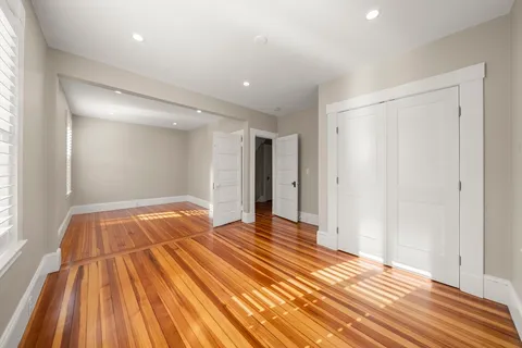 a view of an empty room and wooden floor