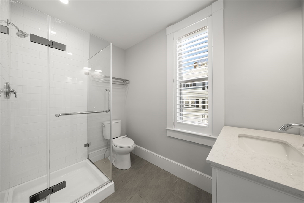 74-76 Butler Road Quincy, MA 02169 - Photo 30 of 41 a bathroom with a sink a toilet and shower