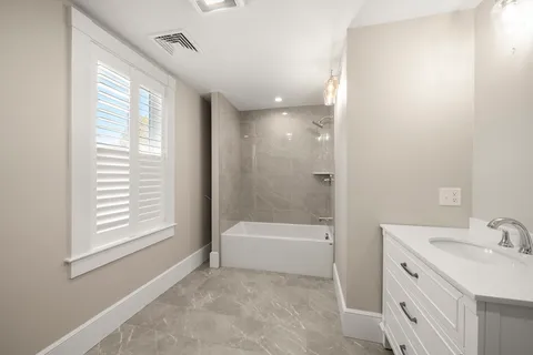 a kitchen with stainless steel appliances kitchen island granite countertop a refrigerator stove top oven and sink