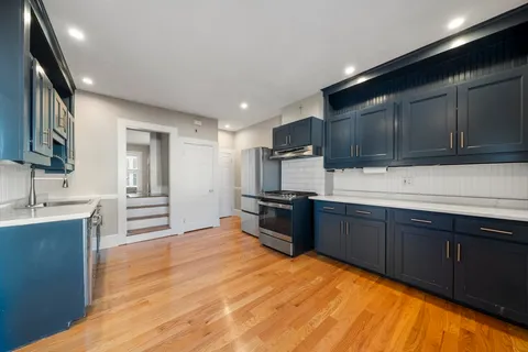 a kitchen with stainless steel appliances and a refrigerator