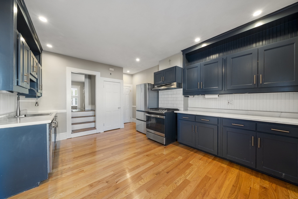 74-76 Butler Road Quincy, MA 02169 - Photo 32 of 41 a kitchen with stainless steel appliances kitchen island granite countertop a refrigerator stove top oven and sink