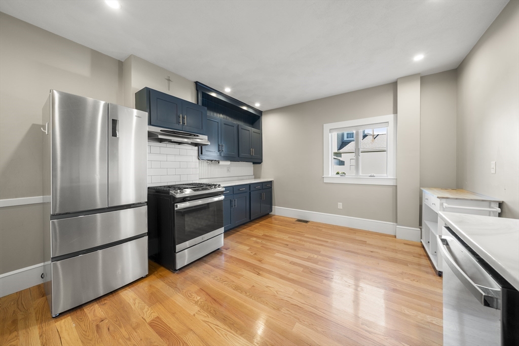 74-76 Butler Road Quincy, MA 02169 - Photo 33 of 41 a kitchen with stainless steel appliances and a refrigerator