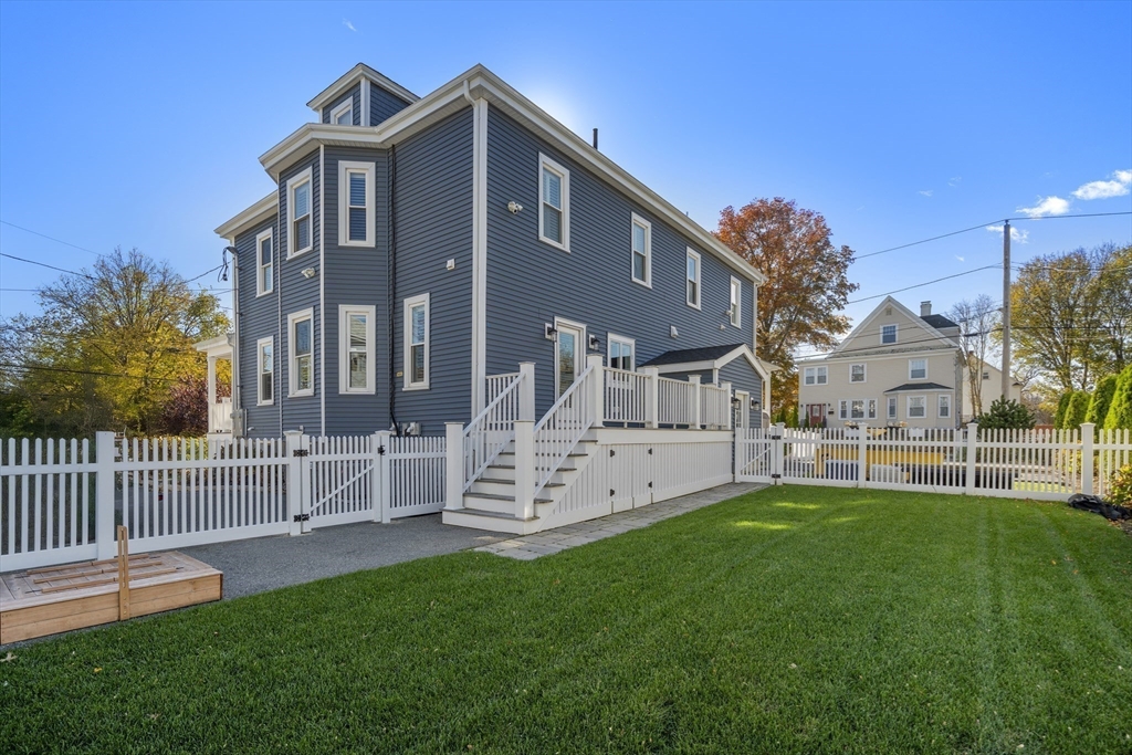 74-76 Butler Road Quincy, MA 02169 - Photo 34 of 41 a front view of a house with a garden and trees