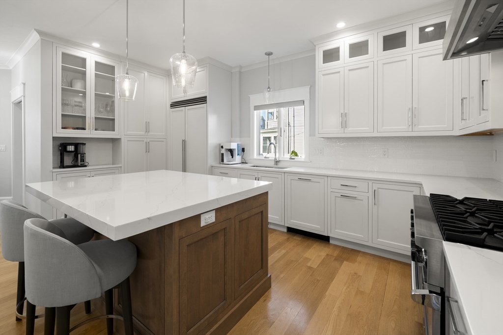 74-76 Butler Road Quincy, MA 02169 - Photo 10 of 41 a kitchen with a sink a stove a refrigerator and white cabinets