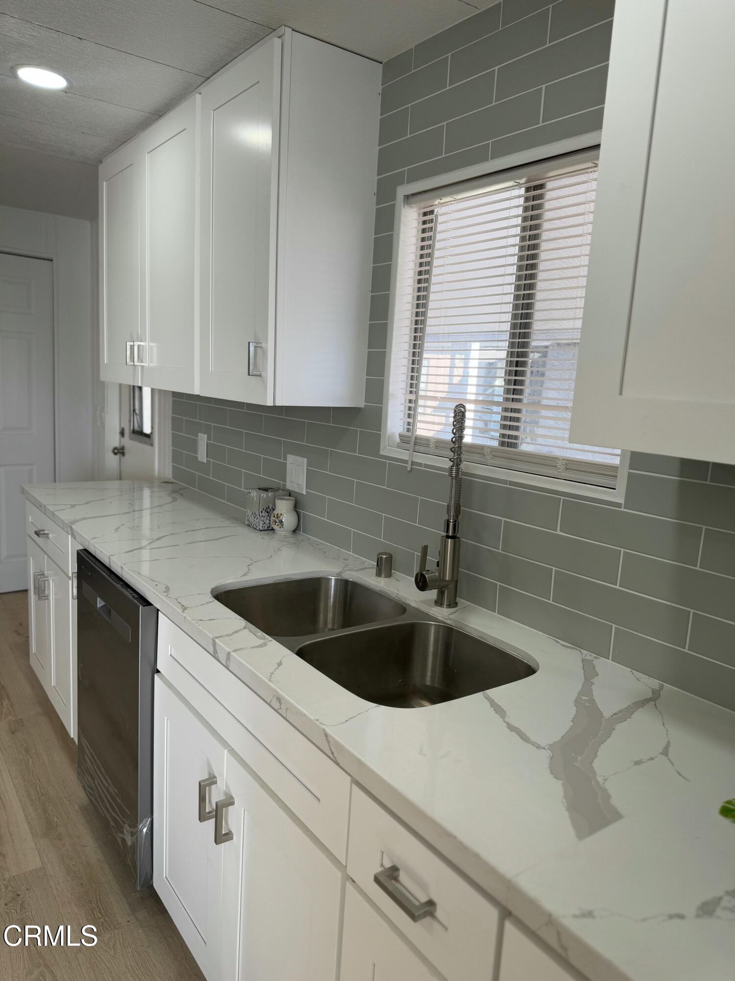 285 Ibsen Place, Unit 10 Oxnard, CA 93033 - Photo 11 of 32 a kitchen with a sink cabinets and window