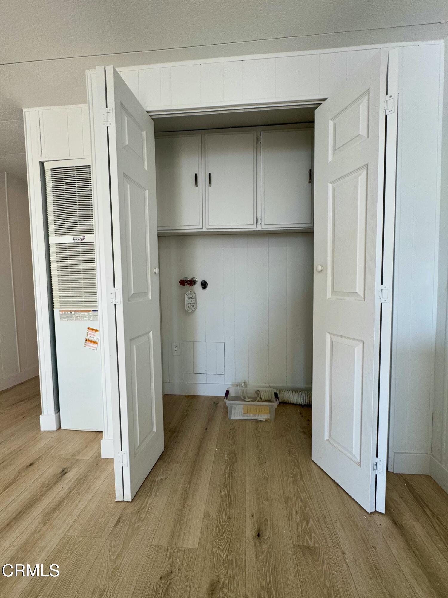 285 Ibsen Place, Unit 10 Oxnard, CA 93033 - Photo 12 of 32 an empty room with wooden floor and a bathroom