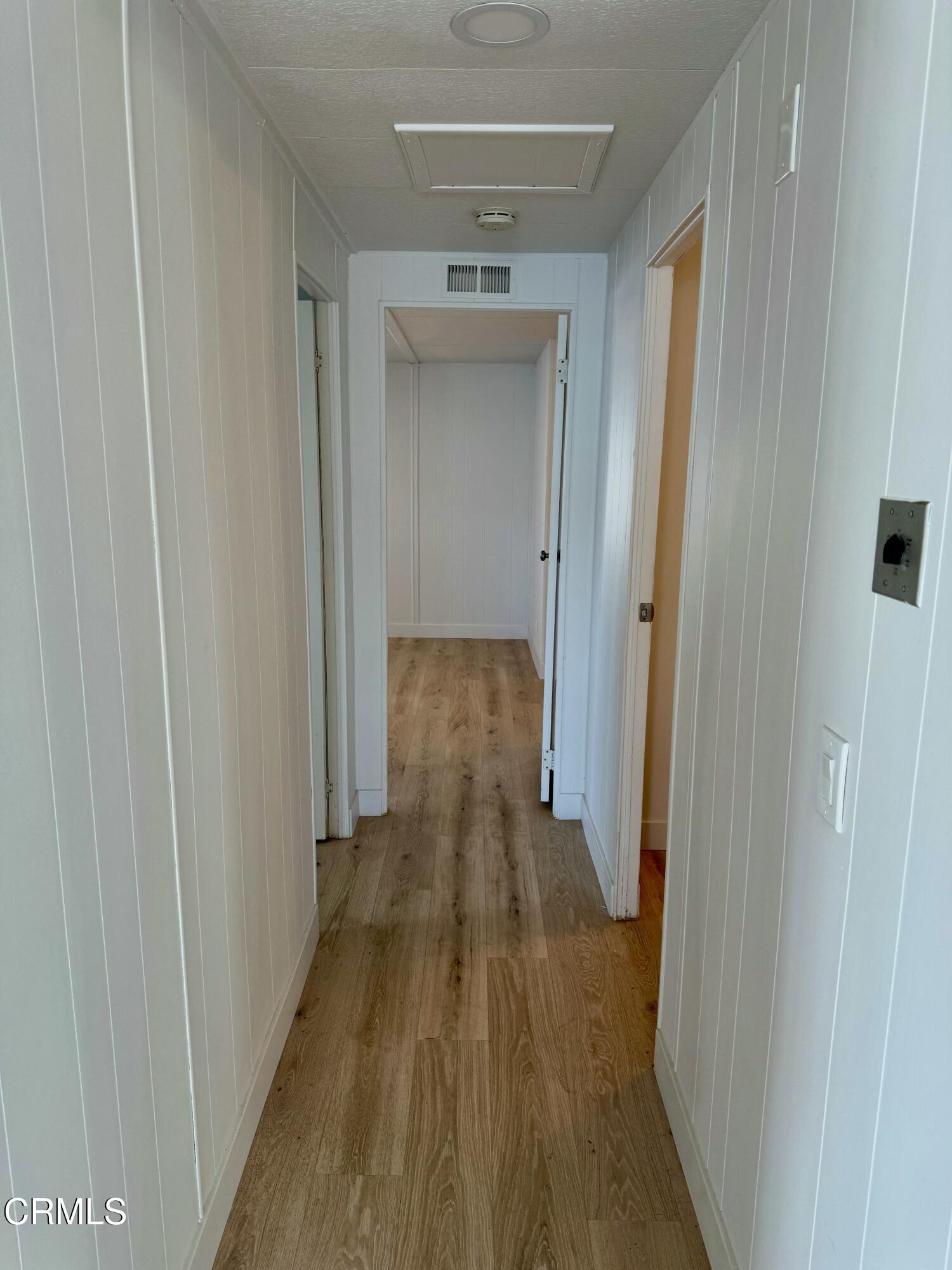 285 Ibsen Place, Unit 10 Oxnard, CA 93033 - Photo 14 of 32 a view of a hallway with wooden floor