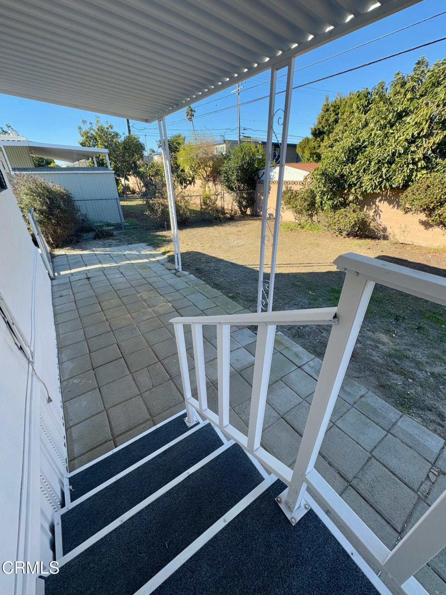 285 Ibsen Place, Unit 10 Oxnard, CA 93033 - Photo 23 of 32 a view of a patio with table and chairs with wooden fence
