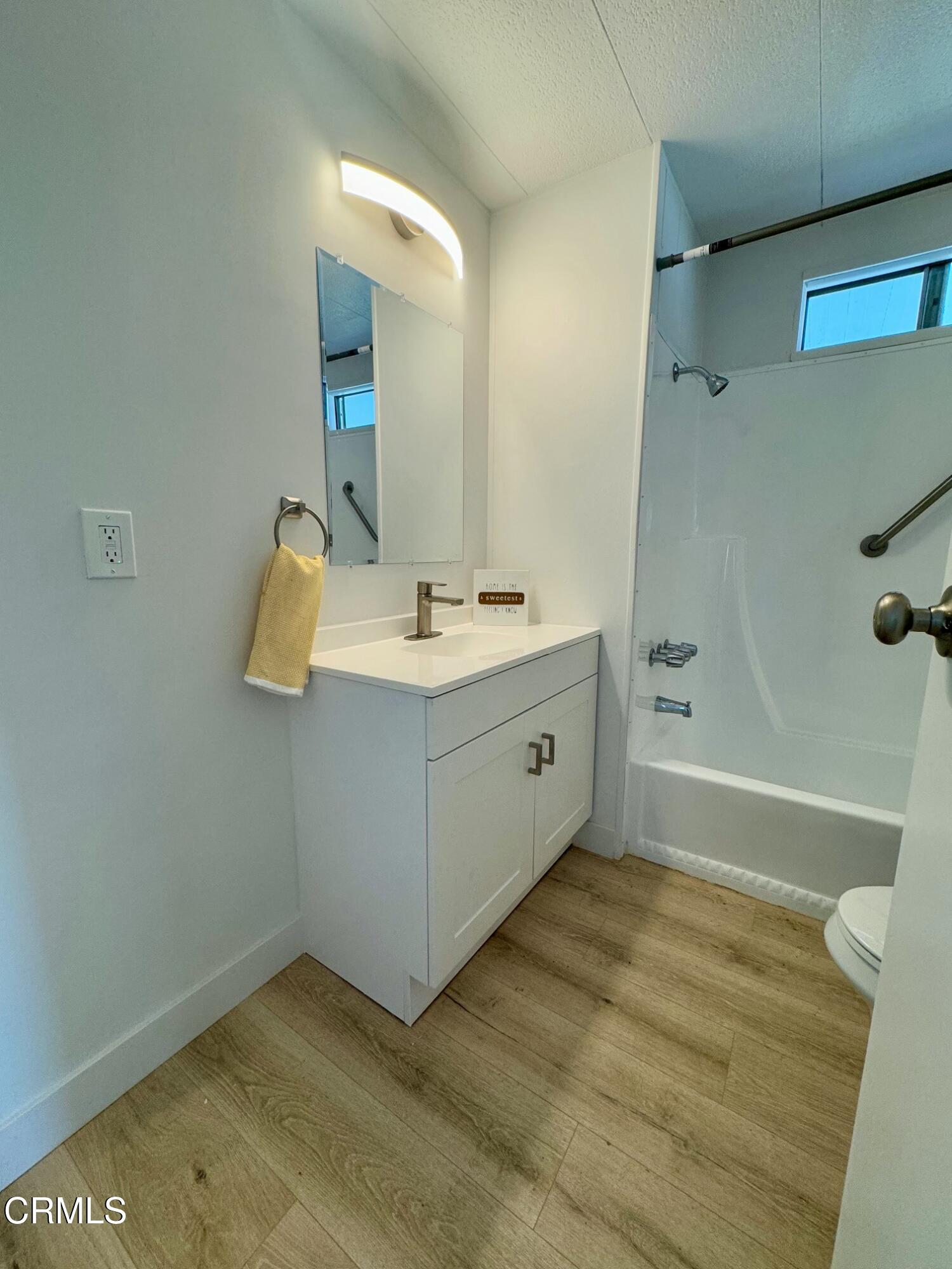 285 Ibsen Place, Unit 10 Oxnard, CA 93033 - Photo 24 of 32 a bathroom with a sink and a mirror