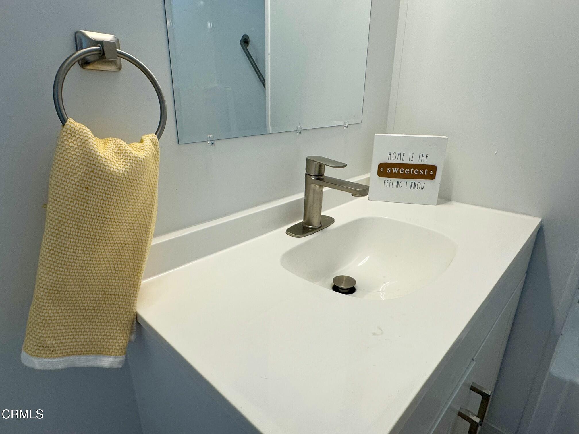 285 Ibsen Place, Unit 10 Oxnard, CA 93033 - Photo 26 of 32 a bathroom with a sink and a mirror