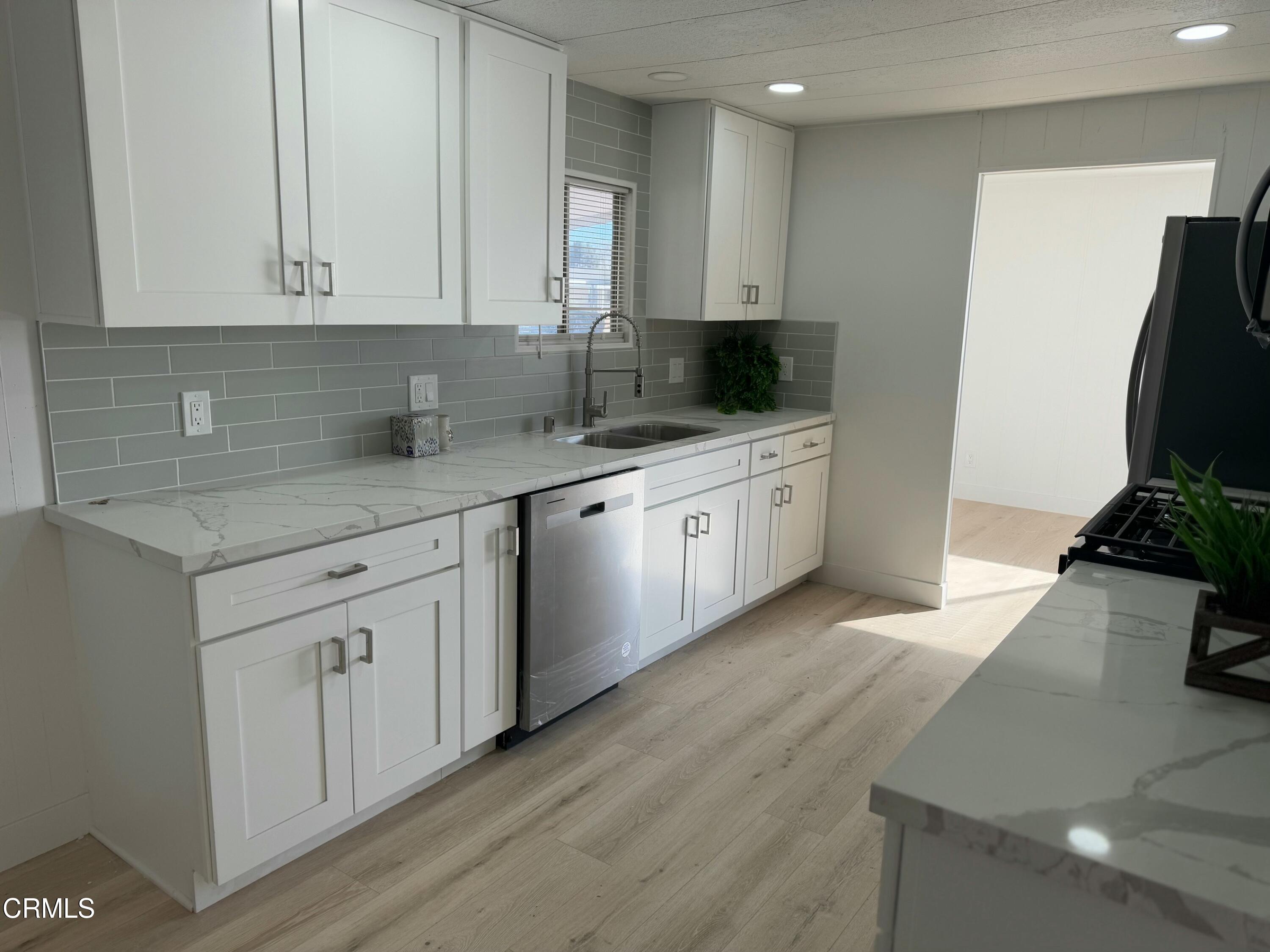 285 Ibsen Place, Unit 10 Oxnard, CA 93033 - Photo 9 of 32 a kitchen with stainless steel appliances granite countertop a sink stove and cabinets