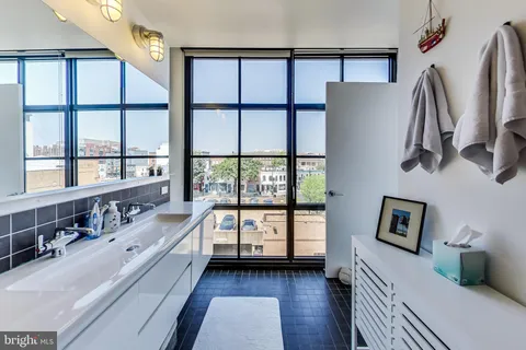 a bathroom with a bathtub and a window