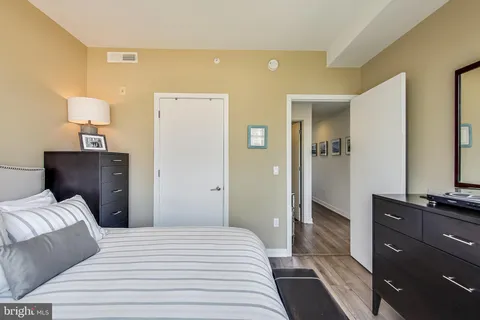 a bedroom with a bed and a dresser