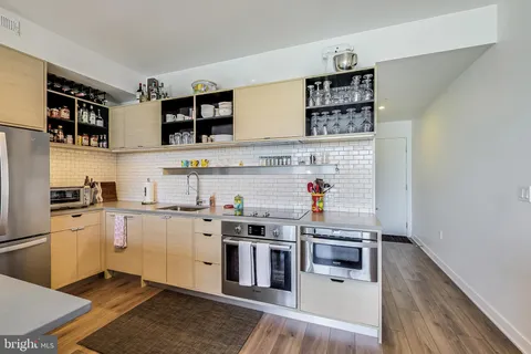 a kitchen with stainless steel appliances granite countertop a stove and a refrigerator